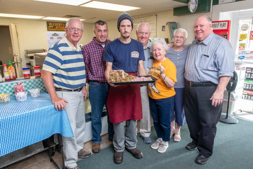  The southern Maryland stuffed ham tradition is supported by folks like, from left, Ray Raley, Matt Bowes, Samuel Pratt, Dan Raley, Carla Tomaszewski, Pat Bowes, and David Dent, pictured here at WJ Dent & Sons country store in Tall Timbers, St. Mary's County.  Photo: Edwin Remsberg Photographs 